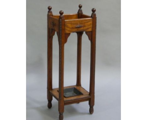 An early 20th century oak stick stand with beaded detail 