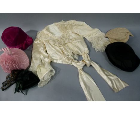 A cream satin and lace blouse with full flared sleeve, together with five various hats 