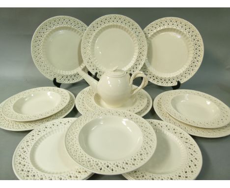 A collection of modern Leeds ware comprising a teapot with flower finial and twin reeded handles, four soup plates, five side