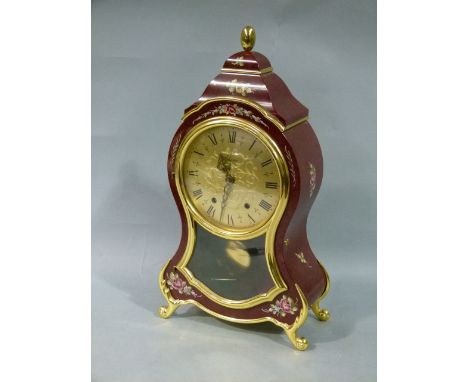 A reproduction Continental mantel clock, having a gilt metal dial with black Roman numerals, striking movement, exposed pendu