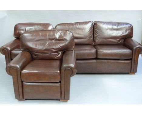 A brown leather three piece suit comprising, two seater sofa and two arm chairs, in good condition 