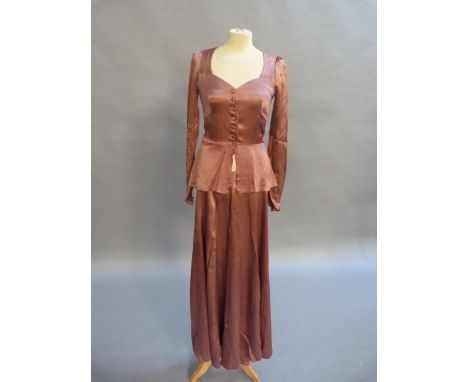 A 1970s Biba dark rose two piece with buttoned front and flared hemline to the blouse top, full sleeves and the full length s