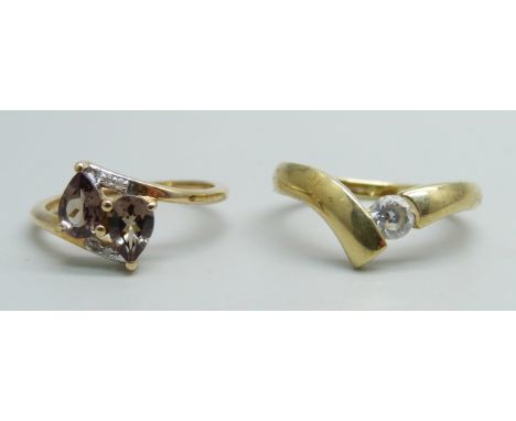 A 14ct gold solitaire ring, 2.1g, M, and a 10k gold crossover ring, 2.1g, L 