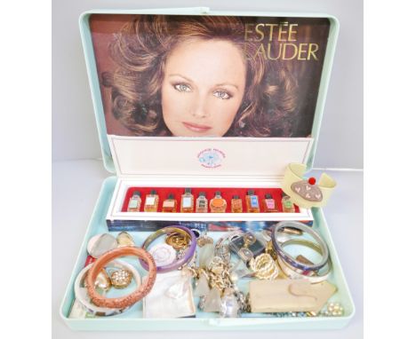 A vintage Estee Lauder case with vintage sample Parfums de France set, vintage make up (used), costume jewellery, mirror comp