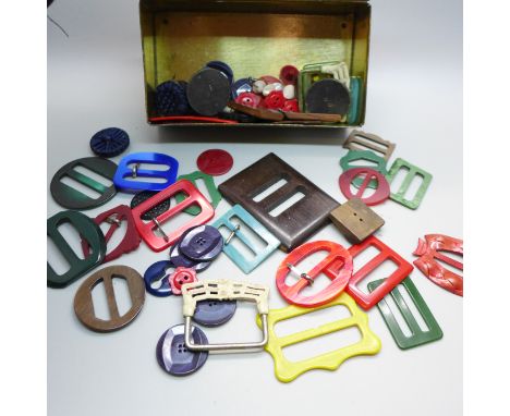 A tin of vintage Bakelite and early plastic buckles, buttons, early 20th Century onwards 