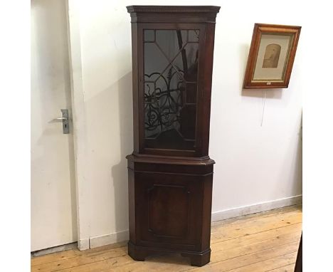 A reproduction mahogany standing corner cabinet of George III design, bearing label for Jenners Department Store the astragal