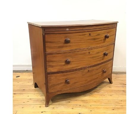 A late George III mahogany bow front chest, c.1800, the rectangular top with moulded edge above three long drawers and a shap