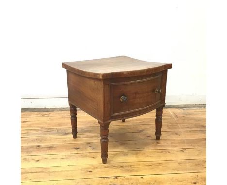 A Regency mahogany commode, the hinged bow fronted top above a false drawer, on turned tapering legs (50cm x 50cm x 46cm)