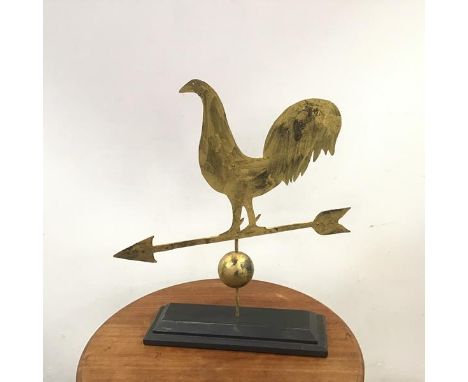 A naive art sculpture in the form of a wind vane with a cockeral on an arrow, cut copper with gold paint (64cm x 59cm x 15cm)