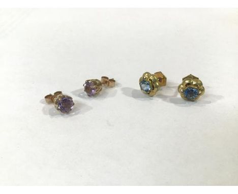 A pair of 9ct gold claw set amethyst stud earrings, and a pair of yellow metal blue stone set earrings (combined: 3.03g)