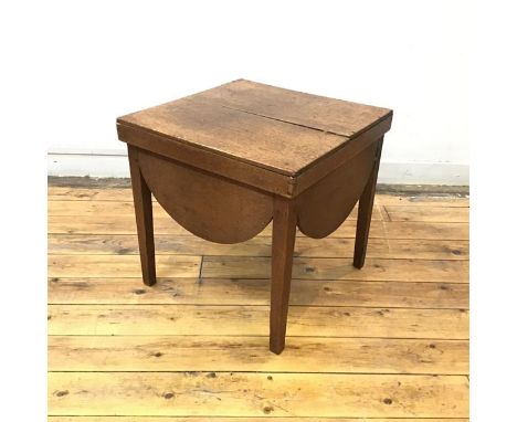 A 19thc oak occasional table, formerly a commode, the oblong top with lunette shaped apron and square section legs (46cm x 47