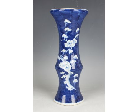 A Chinese blue and white porcelain beaker vase, mark of Kangxi but early 20th century, painted with blossoming prunus branche