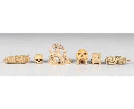 A Japanese carved ivory okimono netsuke, Meiji period, modelled as figures on a fishing boat and bridge, beneath a pine tree,