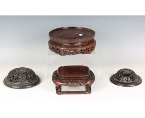 A collection of fifteen mostly Chinese wood stands, late 19th and 20th century, some with carved and pierced decoration, incl