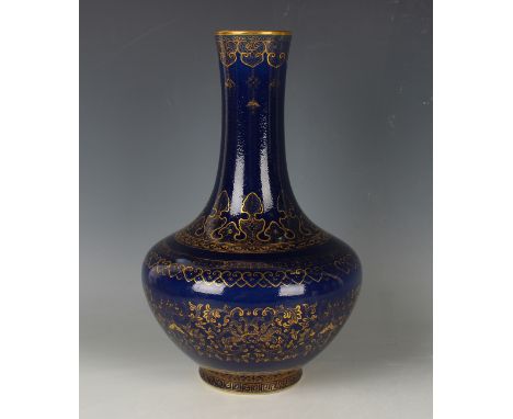 A Chinese gilt decorated blue ground porcelain bottle vase, mark of Qianlong but 20th century or later, the compressed body g