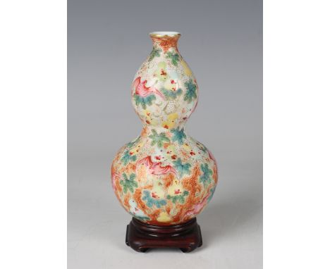 A Chinese famille rose porcelain double gourd shaped vase, mark of Qianlong but probably Republic period, painted and gilt wi