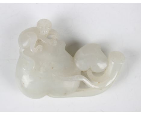 A Chinese white jade carving, probably late Qing dynasty, carved as a monkey seated on a giant peach, length 6.7cm.Buyer’s Pr