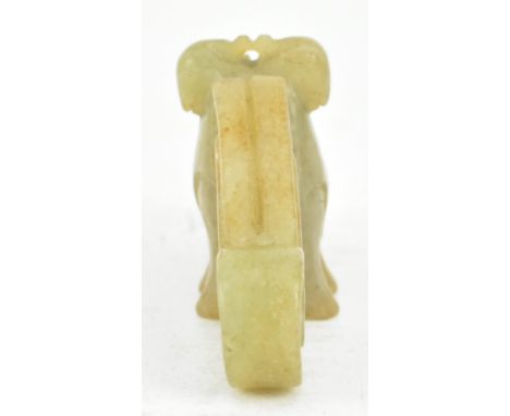 A Ming style celadon jade pendant piece, carved as a mythical bird-like creature, possibly Garuda. The jade carved with doubl