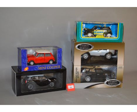Five diecast models, mainly 1:18 scale, including two ERTL Grandes Marques (Range Rover Sport, Land Rover Discovery). Boxed, 