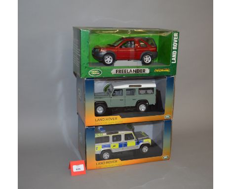 Three boxed Land Rover diecast models in 1:18 scale, including Police version, Defender and Freelander. VG in F-G boxes. (3)