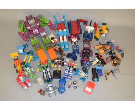 A quantity of unboxed Hasbro Transformers and other transforming robot toys by Bandai and others, including Taiwanese knock o