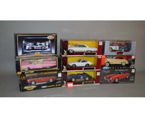 Eight 1:18 scale diecast model cars by Welly, Saico, ERTL, etc. Together with a Maisto Spotlight Display System. All appear V