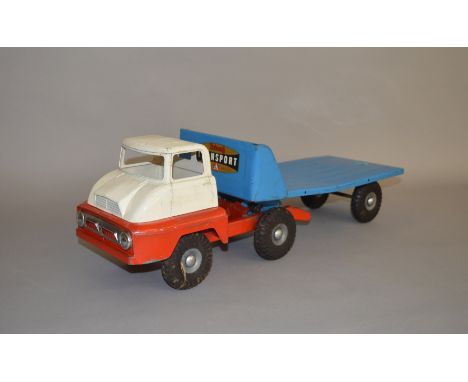 An unboxed Tri-ang pressed steel Thames Trader Mechanical Horse and Flat Truck, missing the original 'boat' load. A first typ