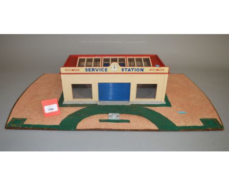 An unboxed Dinky Toys 785 Service Station building, appears complete with all glazing and both blue plastic roller shutter do