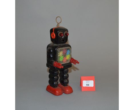 Yoshiya (Japan) High Wheel Robot, black clockwork tinplate robot with red tinplate feet and red plastic hands, clear chest re