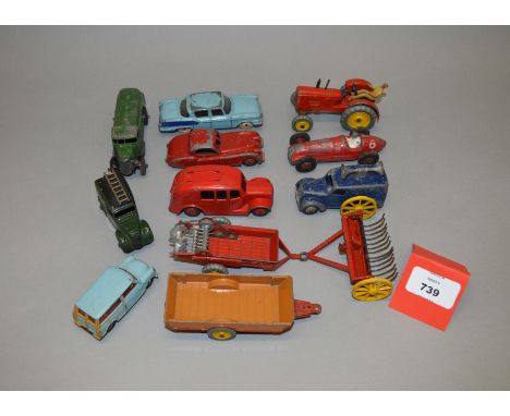 Twelve unboxed playworn Dinky Toys diecast models including a Massey Harris Tractor and a 25d Petrol Tank Lorry in green. Con