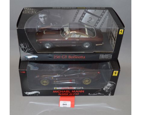 Two boxed Hot Wheels Elite Ferrari diecast model cars in 1:18 scale, a 250 GT Berlinetta and a 599 GTO 'Michael Mann'. Models