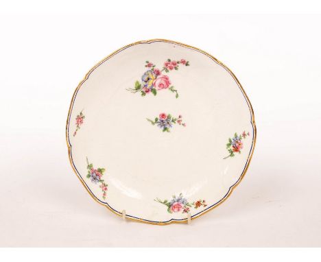 A Sèvres circular dish, date letter t for 1772, moulded with overlapping concentric leaves, painted with scattered flower spr