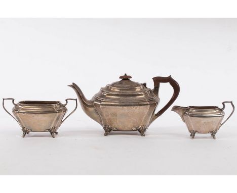 A three-piece silver tea set, JD &amp; S, Sheffield 1932/33, of canted rectangular form on scroll feet, comprising a teapot, 