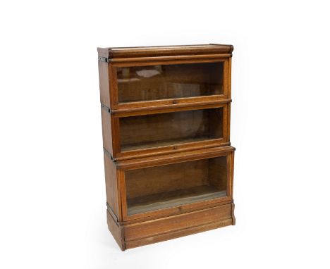 A Globe Wernicke type oak bookcase, the three sections with rising glass panel doors, 86.5cm wide, 130cm high, 38cm deep (max