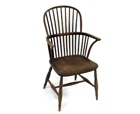 A Windsor type stick back armchair with dished elm seat CONDITION REPORT: The chair is 19th century sound in frame and legs a