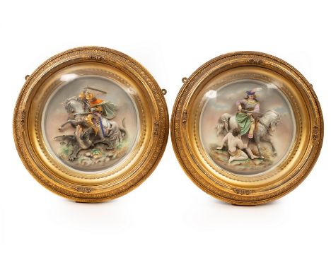 A pair of late 19th Century Continental ceramic plaques, one depicting St George and the Dragon, the other a horseman with fi