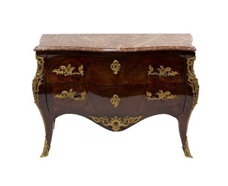 A French kingwood and rosewood ormolu mounted serpentine commode with marble top, fitted two drawers with a fine sunburst ven