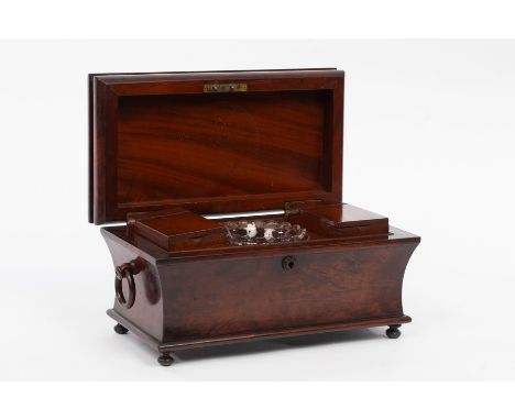 A William IV mahogany sarcophagus-shaped tea caddy on bun feet, the interior fitted two boxes and a mixing bowl, 38.5cm wide