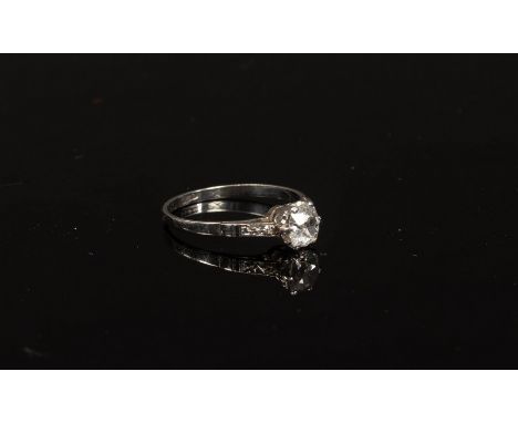 A diamond solitaire ring, the cushion-shaped stone claw set to a platinum shank, size M½