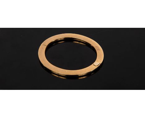 A 9ct yellow gold hinged bangle of flattened form, internal size 53mm x 63mm, approximately 19.1gm  CONDITION REPORT: Clasp a