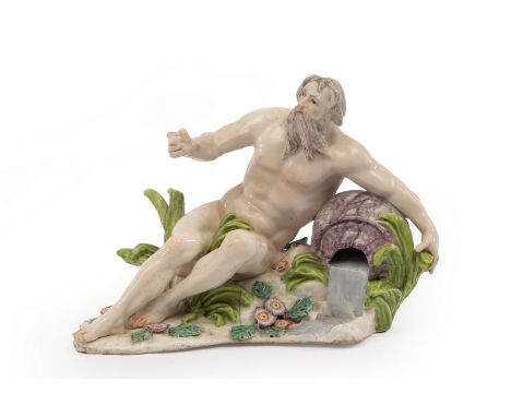 A Chelsea figure of a river God reclining on a rock, circa 1754, encrusted with flowers and foliage, 17cm wide, derived from 