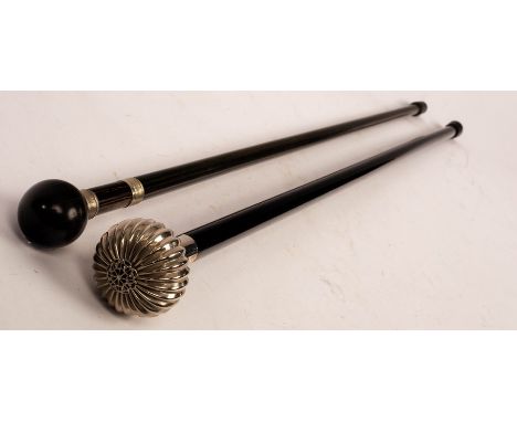 A hardwood walking stick with turned spherical hardwood knop, white metal collars, 88cm long and an ebonised cane with reeded