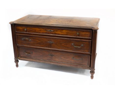 An American walnut commode, circa 1900, the three drawers flanked by fluted three-quarter columns, 139cm wide/Note: Retailers