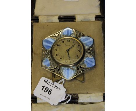 White metal and enamel hexagonal flower head, eight day time piece on easel stand in box.