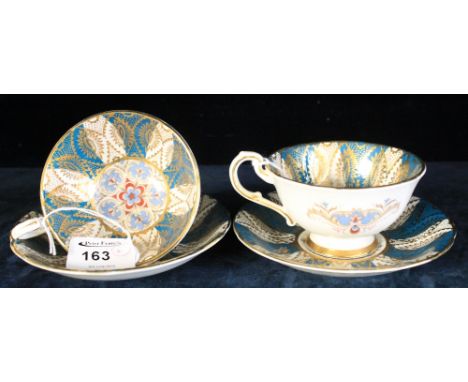 A pair of Paragon fine bone china cabinet cups and saucers with flower head and gilt decoration on a green and white striped 