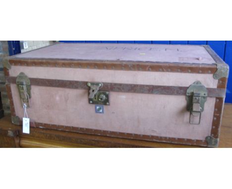 Large rectangular canvas travelling trunk with brass locks and mounts.