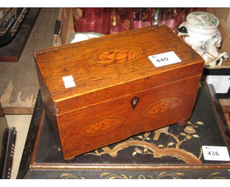 19th Century oak two section tea caddy inlaid with conch shells on bun feet.