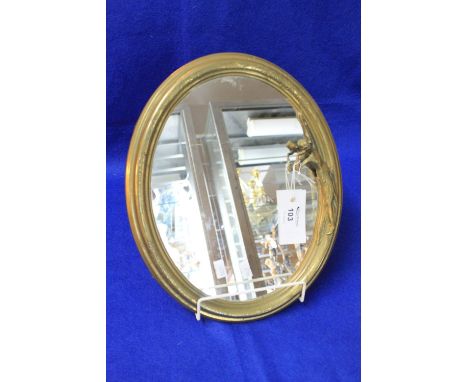 Early 20th Century gilt metal oval mirror easel of Art Nouveau form with lady mounted decoration.