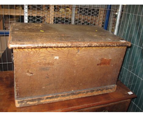 Scrumbled pine rectangular trunk with cast metal carrying handles.