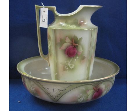 Late 19th Century pottery jug and basin set decorated with fruit on a green ground.  (2)